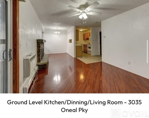 A ground level kitchen, dining, and living room with wood flooring.
