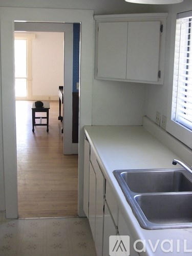 A kitchen with a sink and a window.