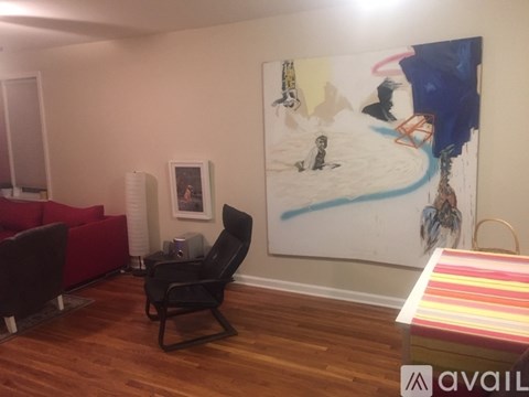 A painting of a beach scene is hanging on the wall in a living room.
