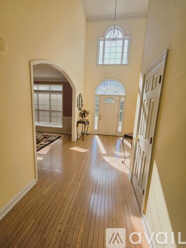 A kitchen with white cabinets and a tiled floor.