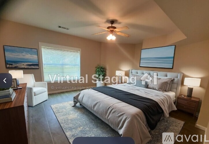A bedroom with a large bed, a ceiling fan, and a window with blinds.
