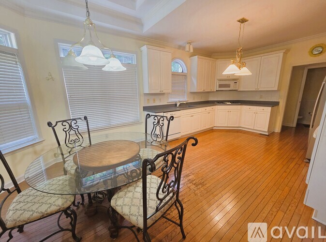 A dining room with a glass table and chairs.