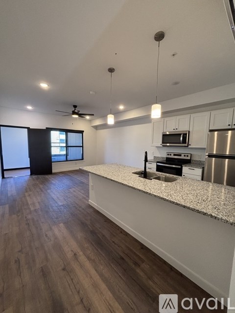 A kitchen with a bar area and a refrigerator.