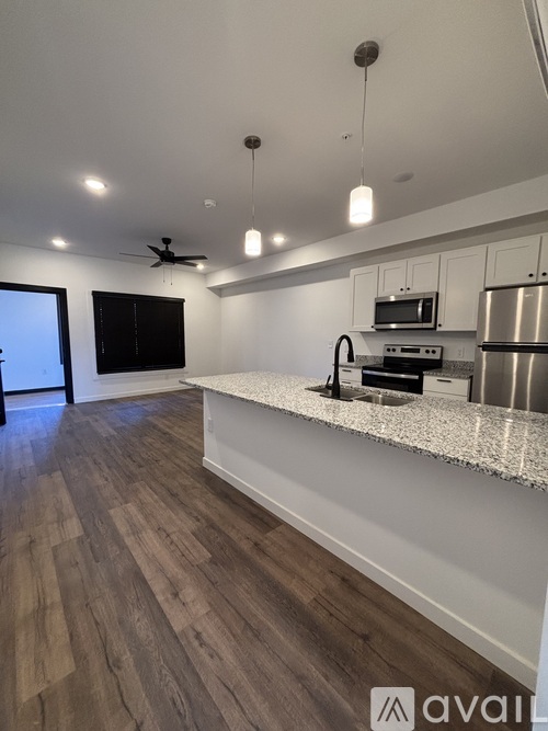 A kitchen with a bar area and a refrigerator.