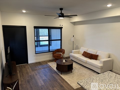 A kitchen with a bar area and a refrigerator.