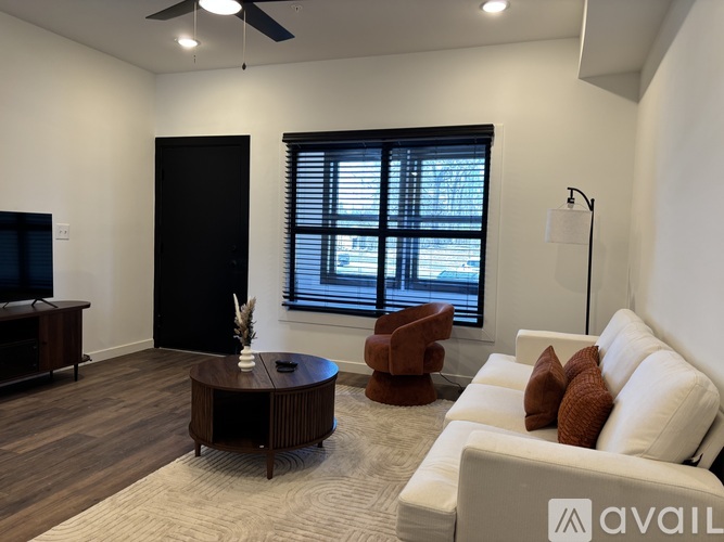 A modern kitchen with a dining table set for two.