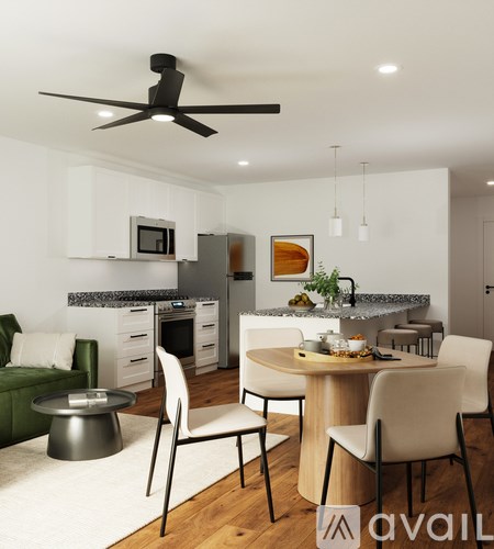 A modern kitchen with a dining table set for two.