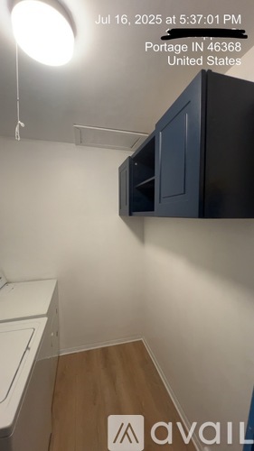 A small, empty room with a washer and dryer.