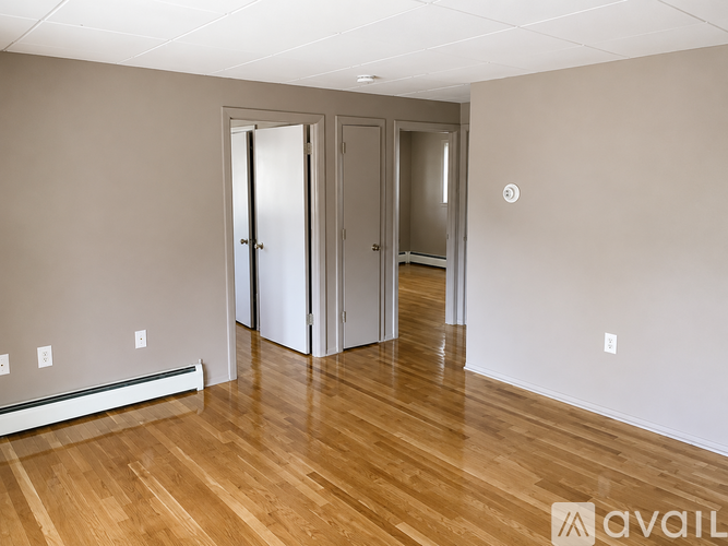 A kitchen with white cabinets and a white refrigerator.