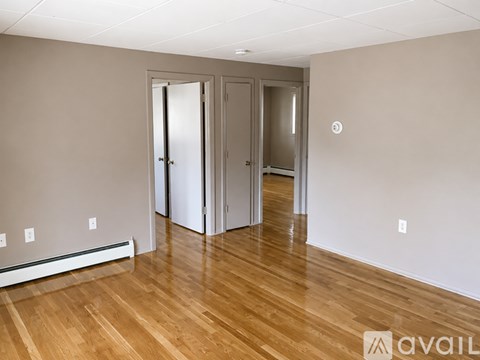 A kitchen with white cabinets and a white refrigerator.