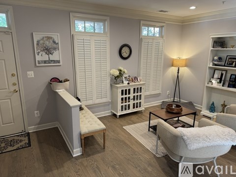 A living room with a white chair and a coffee table.