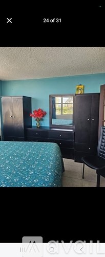 A room with a bed, a dresser, and a chair.