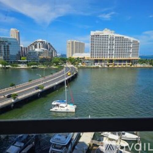 A kitchen with blue walls and wooden cabinets.
