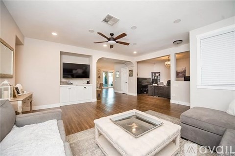 A living room with a grey couch and a white coffee table.