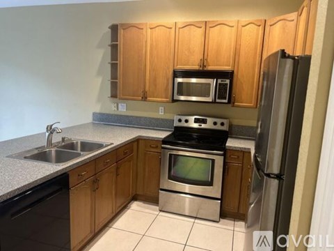 A kitchen with wooden cabinets and stainless steel appliances.