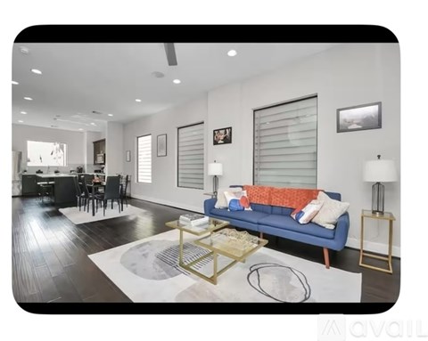 A modern living room with a blue sofa and a coffee table.