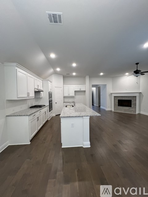 A modern kitchen with white cabinets and a central island.
