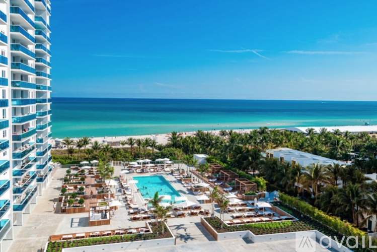 A resort with a pool and a view of the ocean.