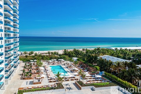 A resort with a pool and a view of the ocean.