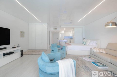 A modern living room with a blue chair and a white couch.