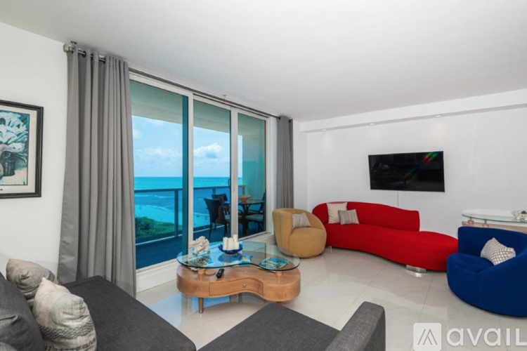 A living room with a view of the ocean through large windows.