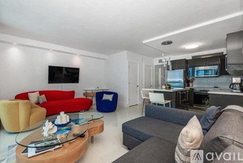 A modern living room with a red sofa and a glass coffee table.
