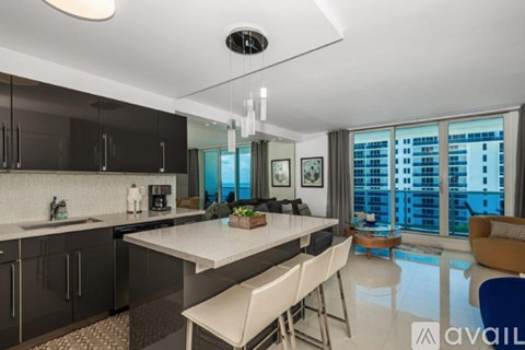 A modern kitchen with a dining table and chairs.
