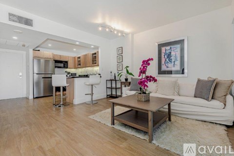 A modern living room with a white couch and a wooden coffee table.