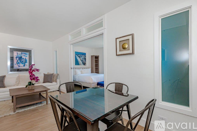 A dining room with a glass table and chairs.