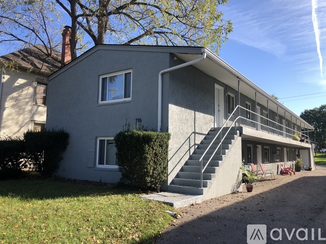 A house with a grey exterior and a staircase leading to the second floor.