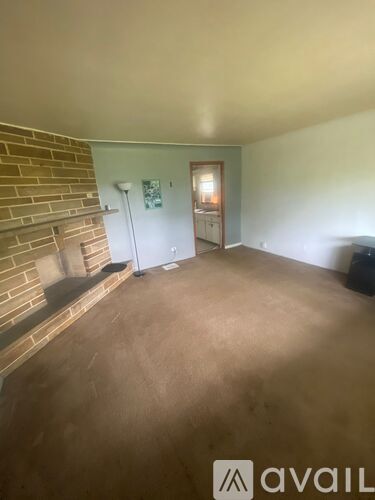 A room with a brick fireplace and a white door.