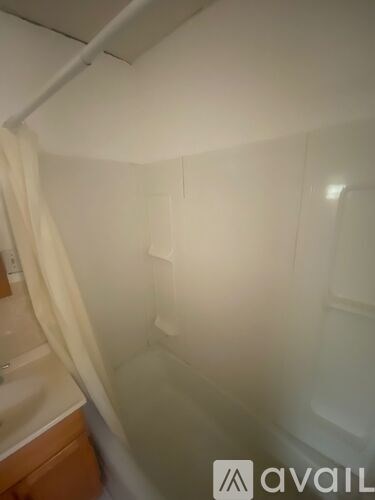A small, empty bathroom with a toilet and sink.