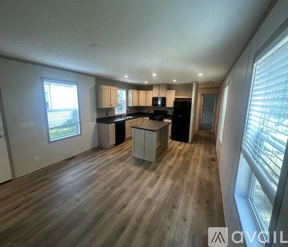 A spacious kitchen with wooden floors and a large island.