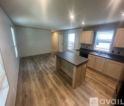 A kitchen with wooden floors and cabinets is available for rent.
