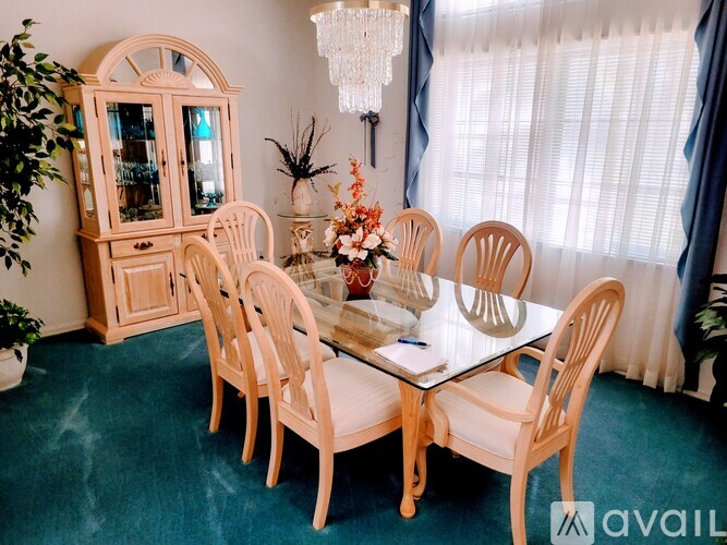 A dining room with a table set for six.