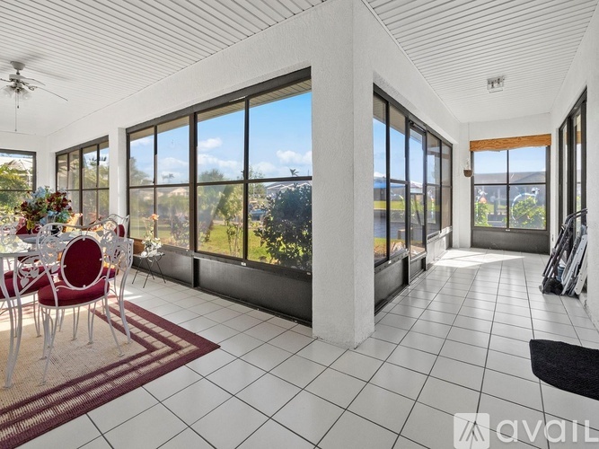 A spacious room with a dining table and chairs is available for rent.