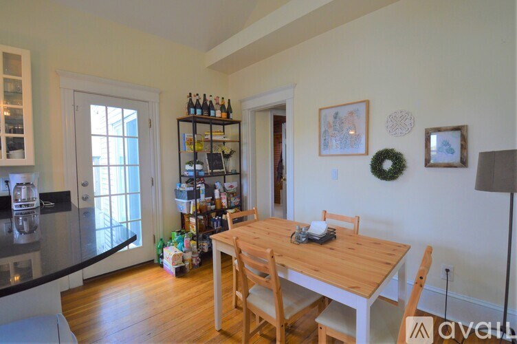 A kitchen with a table and chairs in the middle of the room.