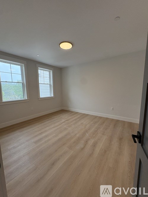 A white refrigerator with a wooden drawer pulled out.