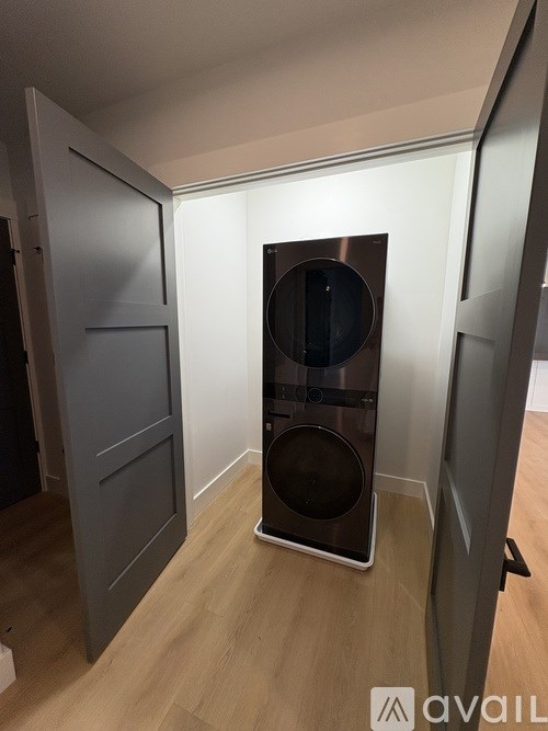 A bedroom with a large bed and a window overlooking a green landscape.