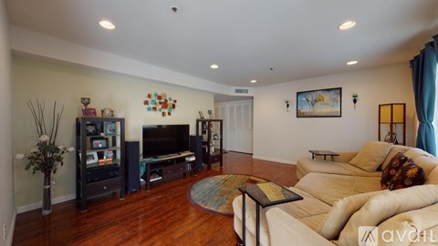 A living room with a white couch and a television.
