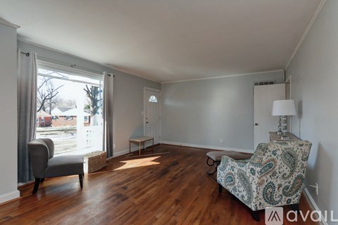 A living room with a couch and a chair.