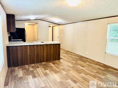 A kitchen with wooden flooring and a countertop.
