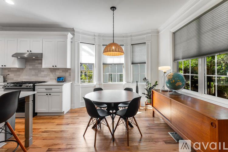 A kitchen with a table and chairs in the middle of the room.