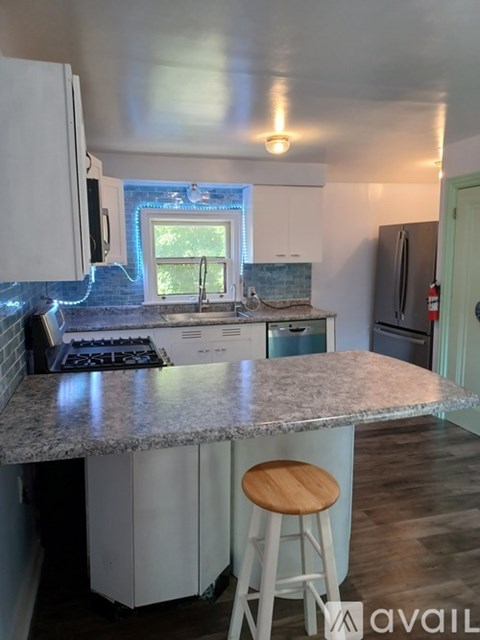 A kitchen with a granite countertop and white cabinets.