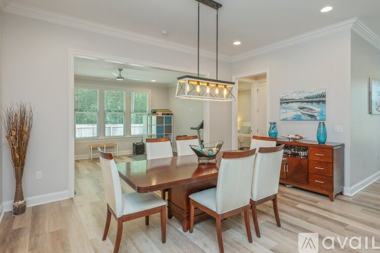 A dining room with a wooden table and chairs.