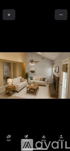 A living room with a white sofa and a wooden coffee table.