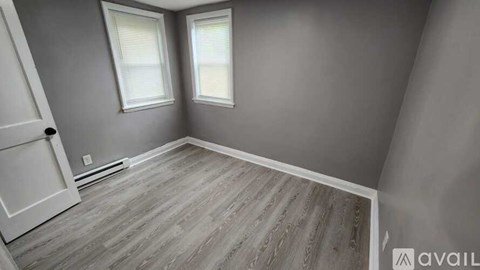 A room with grey walls and a wooden floor.