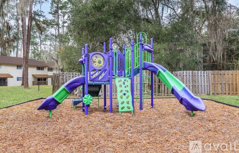 A playground with a purple and green slide.