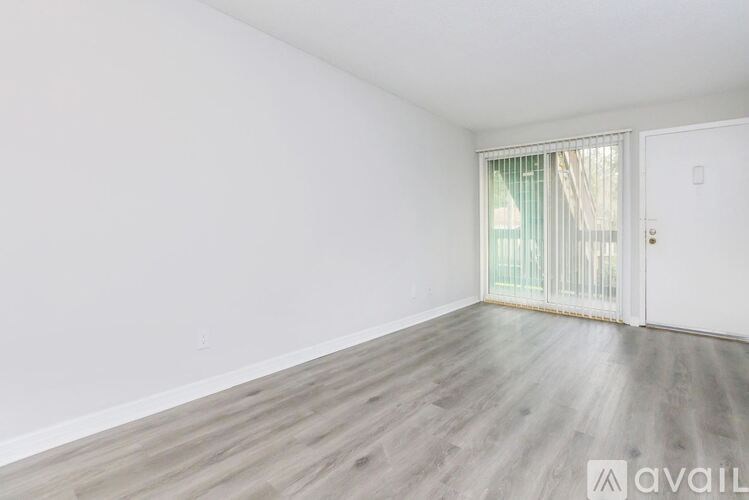 A room with a white door and a window with curtains.