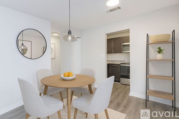 A bedroom with a bed, lamp, and chair.